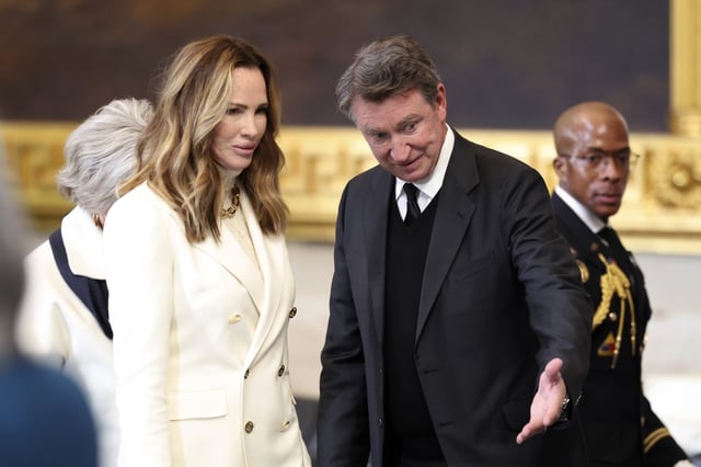 Former NHL player Wayne Gretzky, right, and his wife Janet Jones arrive before the 60th Presidential Inauguration in the Rotunda of the U.S. Capitol in Washington, Monday, Jan. 20, 2025. (Kevin Lamarque/Pool Photo via AP)