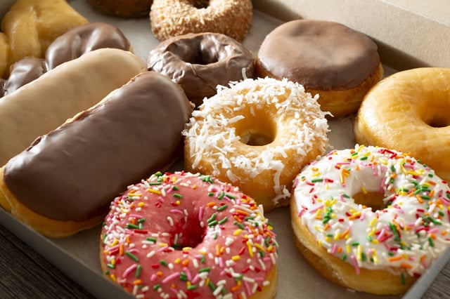 A stock photo dated August 8, 2024, shows donuts in a box. National Donut Day is on Friday, June 6, 2025.