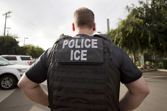 A U.S. Immigration and Customs Enforcement (ICE) officer looks on during an operation in Escondido, Calif., July 8, 2019.