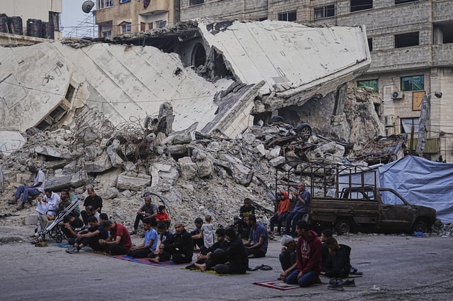 Palestinians gather for Eid al-Adha prayers beside the ruins of Al-Kanz mosque destroyed by Israeli bombardment, in Gaza City on Friday, June 6, 2025. (AP Photo/Jehad Alshrafi)