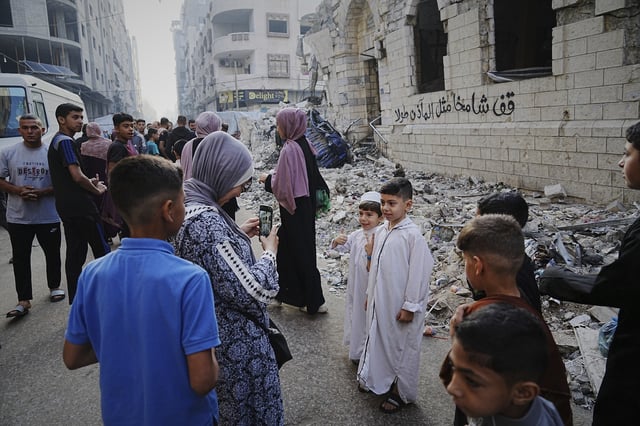 Palestinians gather for Eid al-Adha prayers beside the ruins of Al-Kanz mosque destroyed by Israeli bombardment, in Gaza City on Friday, June 6, 2025. (AP Photo/Jehad Alshrafi)