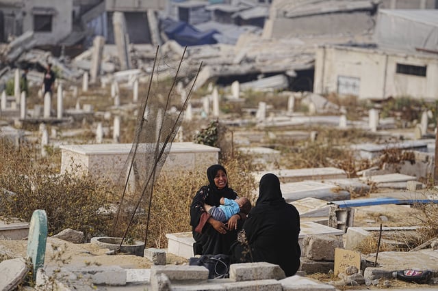 Palestinians visit their relatives graves at Sheikh Radwan cemetery in Gaza City on the first day of Eid al-Adha, Friday, June 6, 2025. (AP Photo/Jehad Alshrafi)