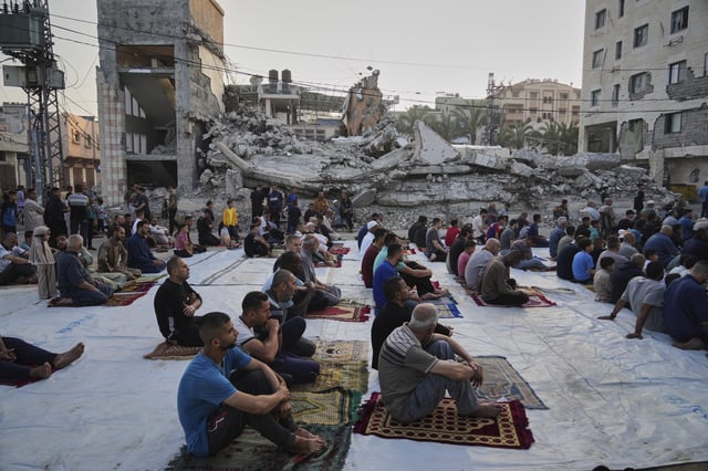 Palestinians gather for Eid al-Adha prayers beside the ruins of a mosque destroyed by Israeli bombardment, in Deir al-Balah, Gaza on Friday, June 6, 2025. (AP Photo/Abdel Kareem Hana)
