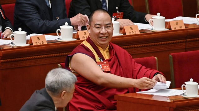 The Chinese government-selected 11th Panchen Lama Gyaincain Norbu meets fellow delegates as they arrive for the opening ceremony of the Chinese People's Political Consultative Conference at the Great Hall of the People in Beijing on March 4, 2024.