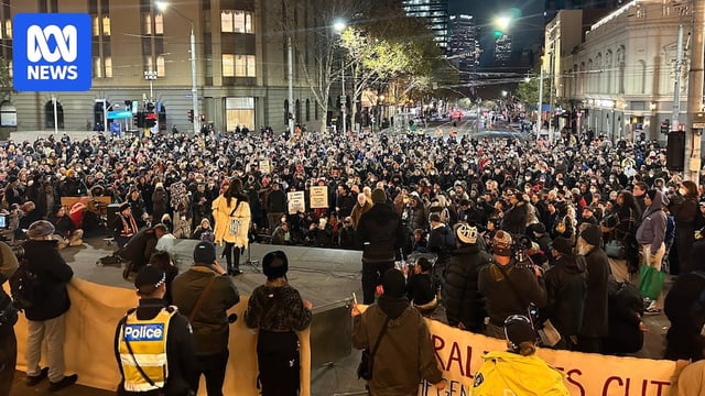A crowd of people gathered in a city CBD.