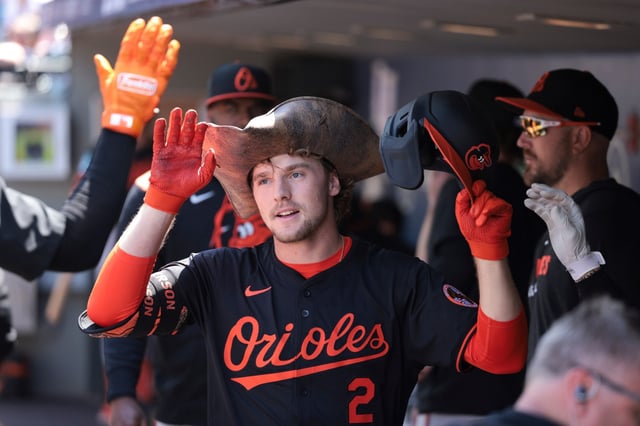 Baltimore Orioles&#39; Gunnar Henderson celebrates in the dugout after hitting a home run off Seattle Mariners starting pitcher Bryan Woo during the sixth inning of a baseball game, Thursday, June 5, 2025, in Seattle. (AP Photo/Jason Redmond)