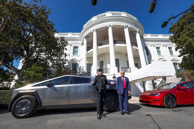 Tesla CEO Elon Musk talks to the media next to U.S. President Donald Trump, with Tesla cars in the background, in front of the White House in Washington, D.C., U.S., March 11, 2025. REUTERS/Kevin Lamarque/File Photo