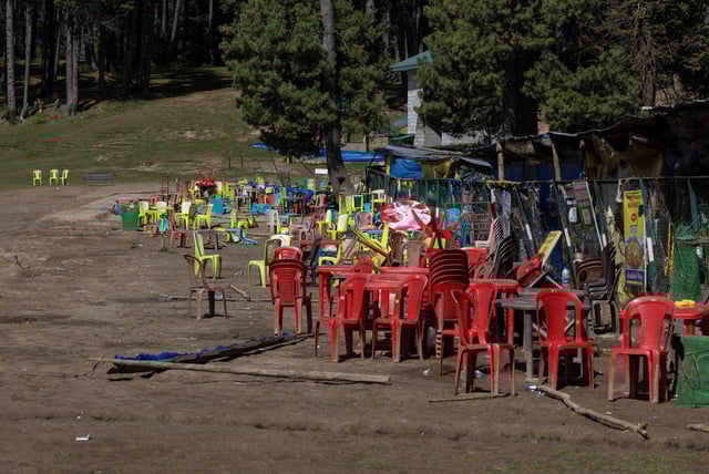 Chairs and tables are scattered at the site of a suspected militant attack on tourists in Baisaran near Pahalgam in south Kashmir's Anantnag district, April 24, 2025. REUTERS/Adnan Abidi/File Photo