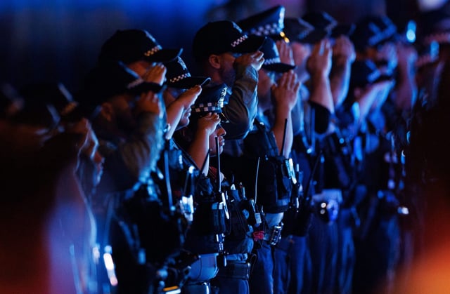 Members of the Chicago police department salute as the body of an officer is brought to the Cook County Medical Examiner’s office, June 6, 2025, after she was fatally shot late Thursday in Chicago&#39;s Chatham neighborhood. (Armando L. Sanchez/Chicago Tribune)