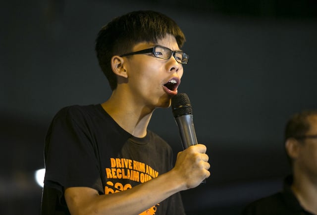 HONG KONG - OCTOBER 19: Student leader Joshua Wong speaks at a pro-democracy protest site outside the central government offices on October 19, 2014 in Hong Kong. Hong Kong's Chief Executive Leung Chun-ying will resume talks on Tuesday between protest groups and government officials. (Photo by Paula Bronstein/Getty Images)
