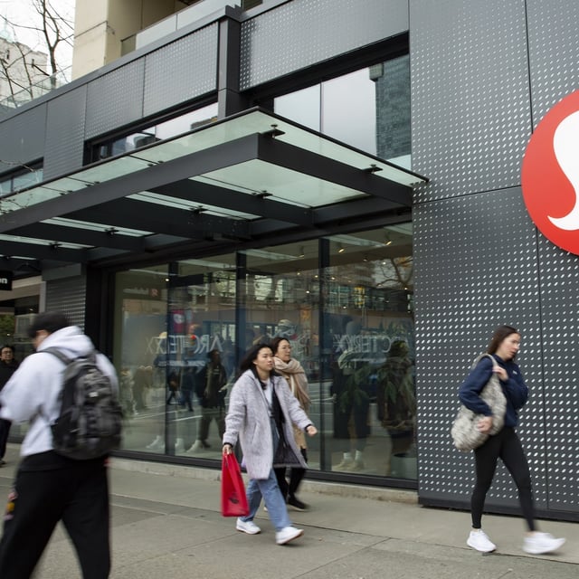 People walk by the Lululemon store on Robson and Burrard in downtown Vancouver on April 1, 2025.