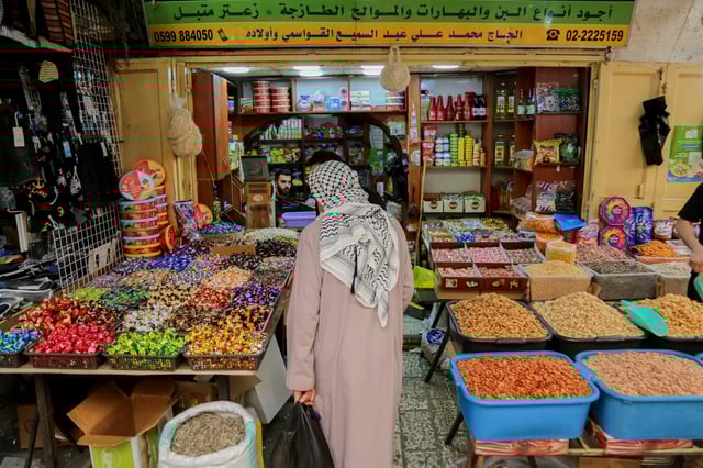 Palestinians buy their necessities in the market as they prepare to celebrate Eid al-Adha, one of the most important Muslim festivities, in Hebron, West Bank, on June 4, 2025.