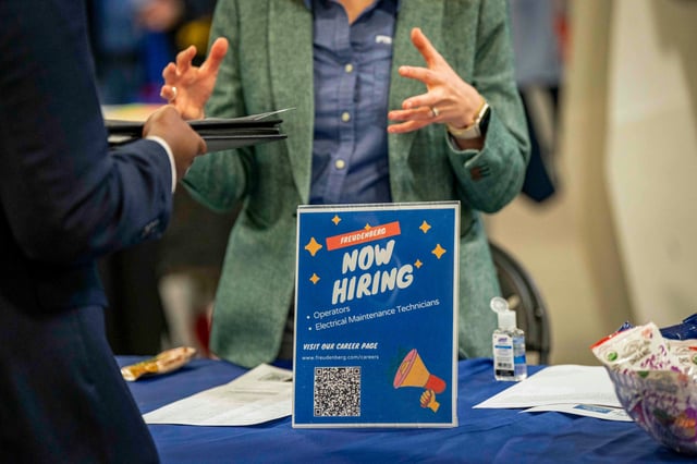 A "Now Hiring" sign at a job and resource fair in Fletcher, N.C., on April 9, 2025.