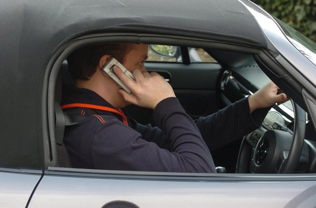 File photo dated 24/03/07 of a man using his mobile phone while driving.