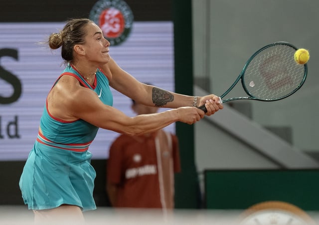 Jun 5, 2025; Paris, FR;  Aryna Sabalenka returns a shot during her match against Iga Swiatek of Poland on day 12 at Roland Garros Stadium. Mandatory Credit: Susan Mullane-Imagn Images