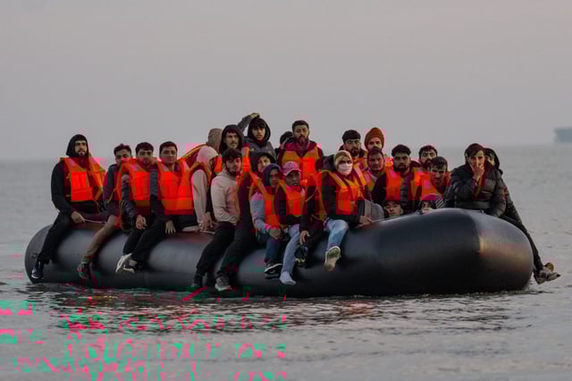 Migrants sit on a dinghy as they prepare to sail into the English Channel on May 31, 2025 in Gravelines, France. (Photo: Carl Court/Getty)
