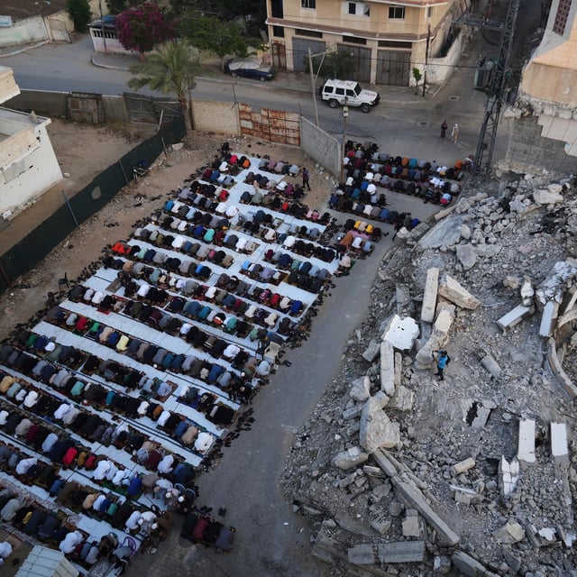 Palestinians offer Eid al-Adha prayers beside the ruins of a mosque destroyed by Israeli bombardment, in Deir al-Balah, Gaza on Friday, June 6, 2025. (AP Photo/Abdel Kareem Hana)