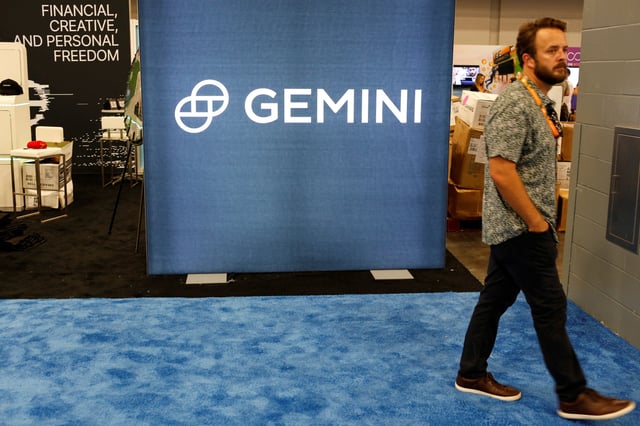 A man walks past the logo of Gemini Trust, a digital currency exchange and custodian, during the Bitcoin Conference 2022 in Miami Beach, Florida, U.S. April 6, 2022. REUTERS/Marco Bello/File Photo