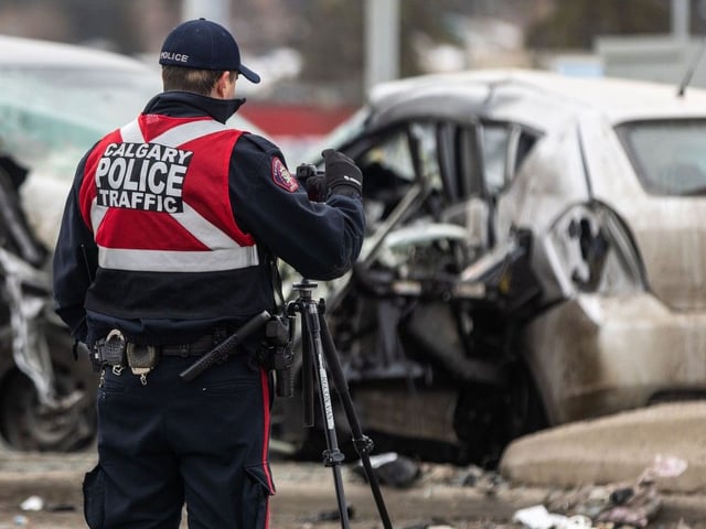 Emergency crews work at the scene of a multi-vehicle collision at the intersection of Macleod Trail and Southland Drive in Calgary on December 26, 2024.