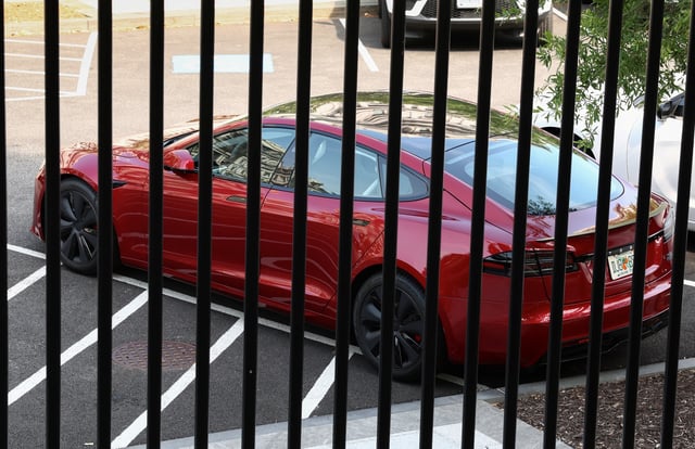 A Tesla vehicle purchased by U.S. President Donald Trump earlier this year is parked in West Executive Avenue, between the White House and the Eisenhower Executive Office Building, in Washington, D.C., U.S., June 6, 2025. REUTERS/Kevin Lamarque