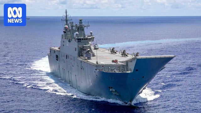 An Australian warship in the middle of the ocean with another warship in the distance background.