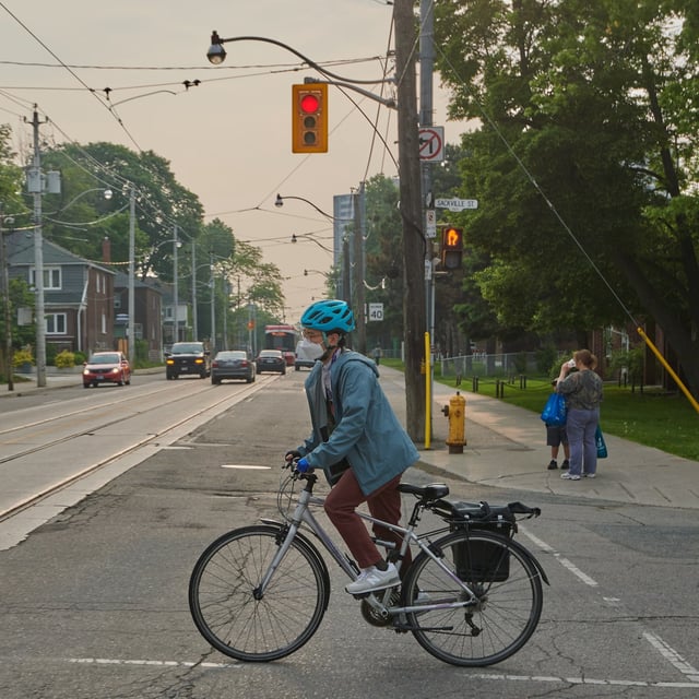 Cyclists commute in Toronto’s east end as wildfire smoke rolls into the city on June 6, 2025. (Sammy Kogan/The Globe and Mail)