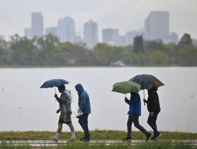 Rain continues to fall as people walk around Sloans Lake in Denver on May 7, 2025. (Photo by RJ Sangosti/The Denver Post)