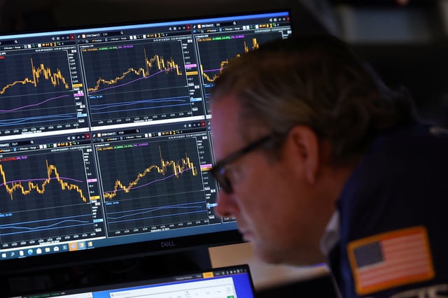 A trader works on the trading floor at The New York Stock Exchange (NYSE) in New York City, U.S., September 18, 2024. REUTERS/Andrew Kelly/File Photo