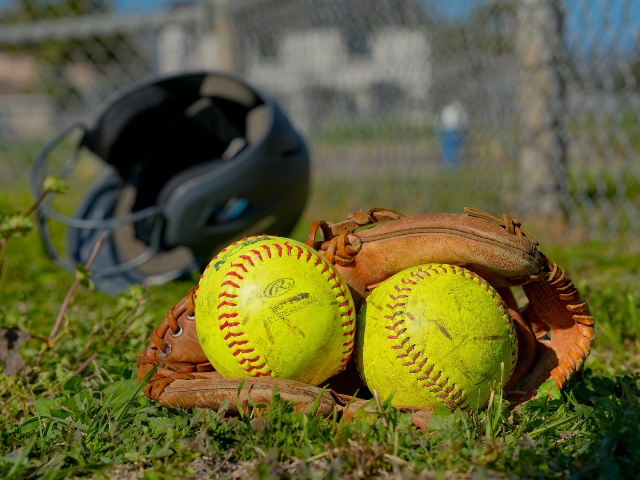 Balls on Glove on Grass