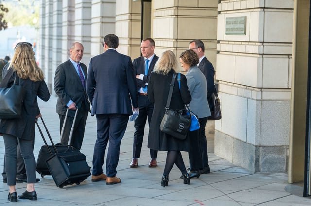 AP attorney Charles Tobin, center left, talks with AP White House correspondent Zeke Miller, center with back to camera, and AP chief Washington photographer Evan Vucci, center right, outside the E. Barrett Prettyman Federal Courthouse following a hearing on The Associated Press' lawsuit against the Trump administration to restore access to presidential events on March 27 in Washington, DC.
