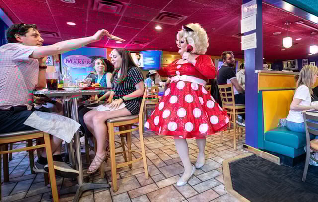 Drag Queen Gidget Galore makes her way through Hamburger Mary&#39;s restaurant entertaining the packed house on the last night of Drag Bingo as well as picking up tips from the crowd in Orlando on Tuesday, May 28, 2024.