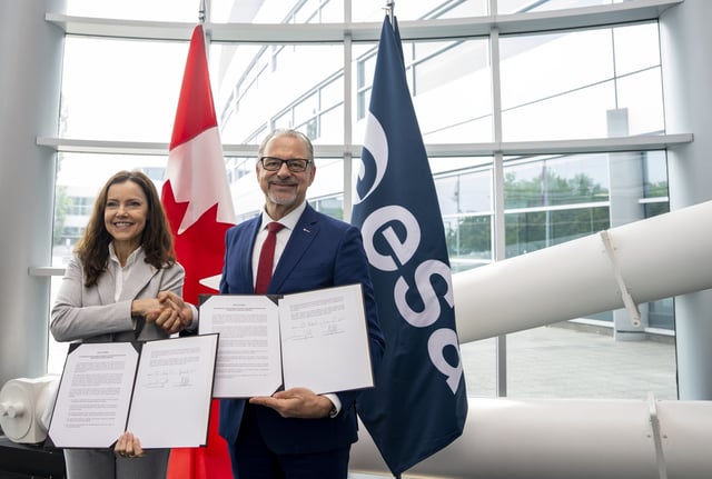 Director General of the European Space Agency (ESA), Josef Aschbacher, right and Canada Space Agency President Lisa Campbell display their signed re-affirmations of the Canada-European Space Agency Cooperation Agreement in Longueuil, Que., on Friday, June 6, 2025. 