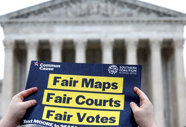 Demonstrators gather outside of the United States Supreme Court as the justices hear oral arguments in Moore v. Harper, a Republican-backed appeal to curb judicial oversight of elections, in Washington, U.S., December 7, 2022. REUTERS/Evelyn Hockstein/File Photo