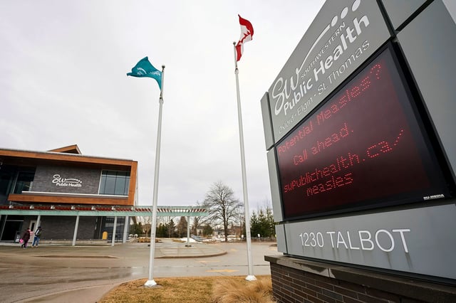 A sign outside Southwestern Public Health in St. Thomas, Ontario, Canada, on Tuesday, March 4, 2025, warns residents to call ahead before visiting a doctor or hospital if they think they have the measles. (Geoff Robins/The Canadian Press via AP)