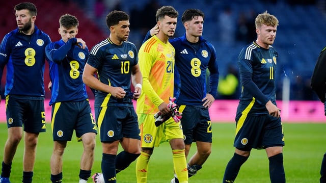 Slicker, centre, is consoled by Scotland team-mates