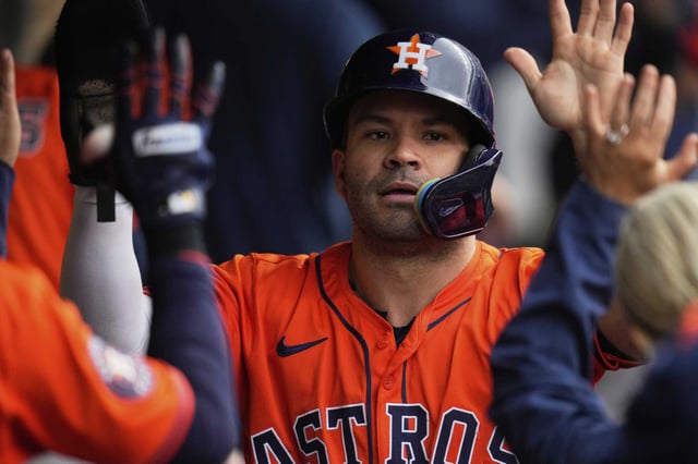 Houston Astros&#39; Jose Altuve is congratulated in the dugout after scoring in the fifth inning of a baseball game against the Cleveland Guardians in Cleveland, Friday, June 6, 2025. (AP Photo/Sue Ogrocki)