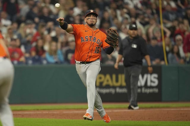 Houston Astros third baseman Isaac Paredes (15) catches a fly ball hit for an out and throws to first base for the out on David Fry in the eighth inning of a baseball game in Cleveland, Friday, June 6, 2025. (AP Photo/Sue Ogrocki)