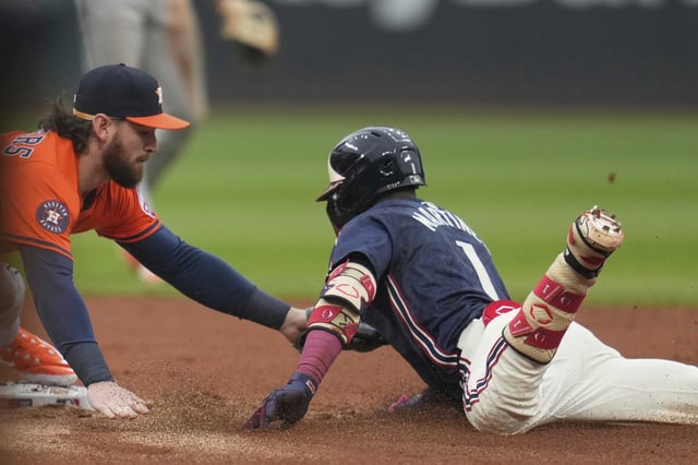 Houston Astros second baseman Brendan Rodgers, left, tags out Cleveland Guardians&#39; Angel Martinez (1) at second base in the first inning of a baseball game in Cleveland, Friday, June 6, 2025. (AP Photo/Sue Ogrocki)