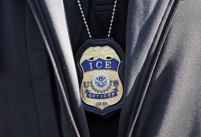 A viral video of an ICE agent smashing a window in New Bedford is not the same man as a militia founder who lives in Oklahoma, a media investigation found. (Staff Photo By Matt Stone/MediaNews Group/Boston Herald)