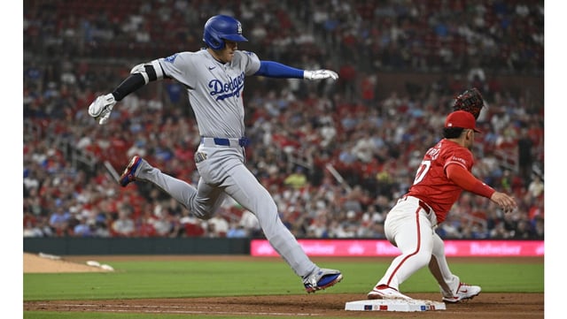 Dodgers star Shohei Ohtani, left, can’t beat the throw to St. Louis Cardinals first baseman Willson Contreras on a ground out in the seventh inning on Friday night in St. Louis. The Dodgers were shut out for the fourth time this season, 5-0. (AP Photo/Joe Puetz)
