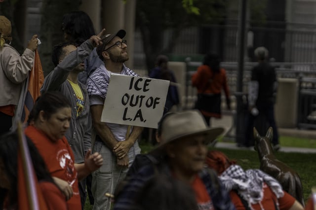 A man holds a placard calling for ICE to get out of Los Angeles, as thousands of people fill the streets of Los Angeles, California on May 1, 2025 to attend the rally of May Day, also known as Workers&#39; Day.
