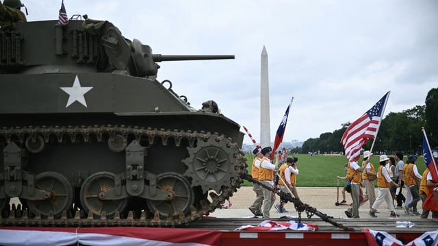 A trailer towing an Army tank passes by the Washington Monument during a Memorial Day parade last month. Photo: Brendan Smialowski/AFP via Getty Images