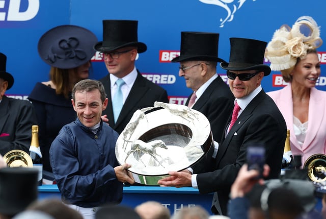 Horse Racing - The Epsom Derby - Epsom Downs Racecourse, Surrey, Britain - June 7, 2025 Wayne Lordan and trainer Aidan O'Brien celebrate with the trophy after winning the 15:30 Betfred Derby with Lambourn Action Images via Reuters/Matthew Childs