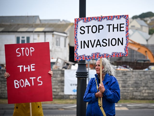 PORTLAND, ENGLAND - SEPTEMBER 16: Protesters against illegal immigration and the Bibby Stockholm barge demonstrate, on September 16, 2023 in Portland, England. The floating accommodation has been hired by the UK Home Office to house between 400 and 500 asylum seekers, although its first residents were evacuated days after their arrival in August following the discovery of Legionella bacteria in the barge's water system. (Photo by Finnbarr Webster/Getty Images)