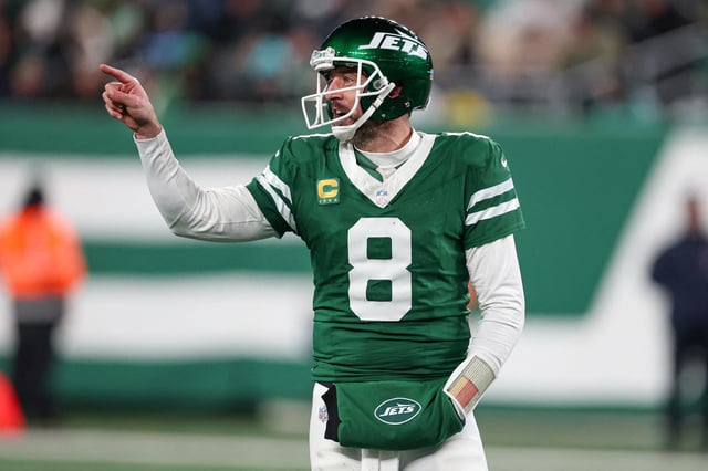 Jan 5, 2025; East Rutherford, New Jersey, USA; New York Jets quarterback Aaron Rodgers (8) gestures towards the Miami Dolphins bench during the second half at MetLife Stadium. Mandatory Credit: Vincent Carchietta-Imagn Images/File Photo