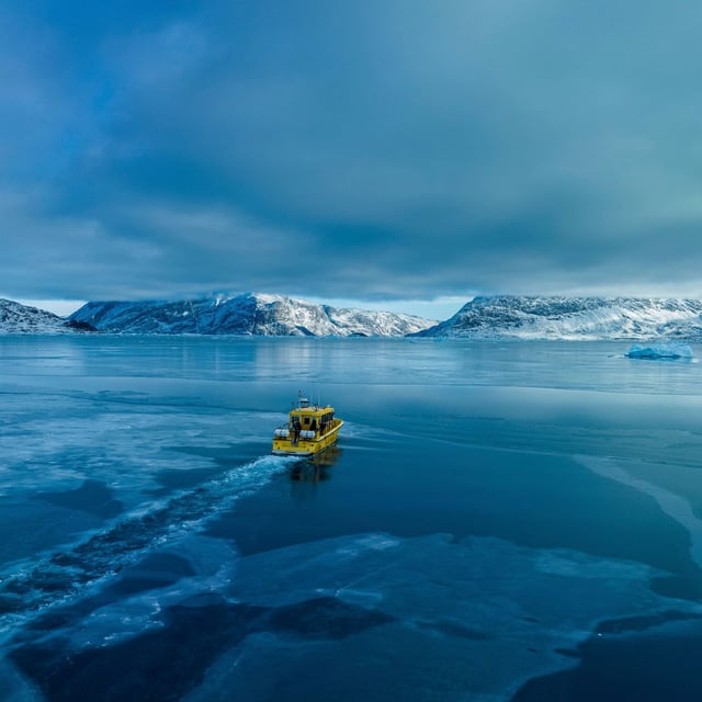 FILE -A boat rides though a frozen sea inlet outside of Nuuk, Greenland, March 6, 2025. (AP Photo/Evgeniy Maloletka, File)