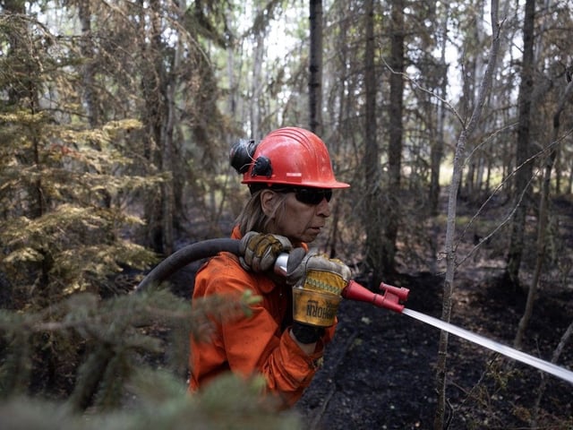Firefighter Warren Lavallee who is from Weyakwin spares water on hotpots during the Ditch02 fire on Saturday, May 31, 2025 in Weyakwin.