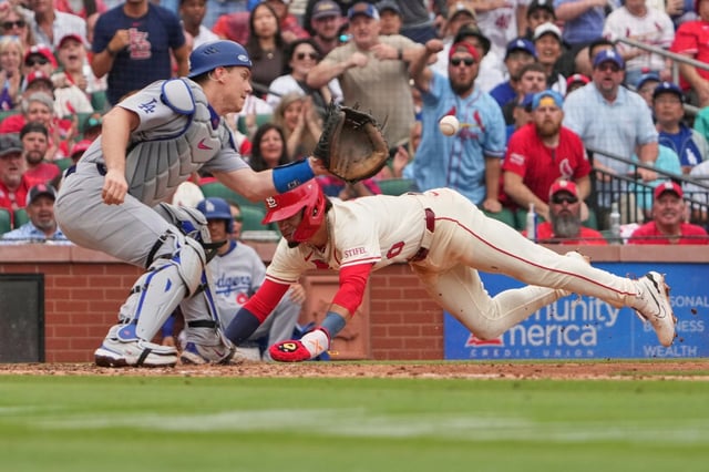 The Cardinals’ Masyn Winn slides and scores the first run of the game past Dodgers catcher Will Smith during the eighth inning Saturday, June 7, 2025, in St. Louis. (AP Photo/Jeff Roberson)