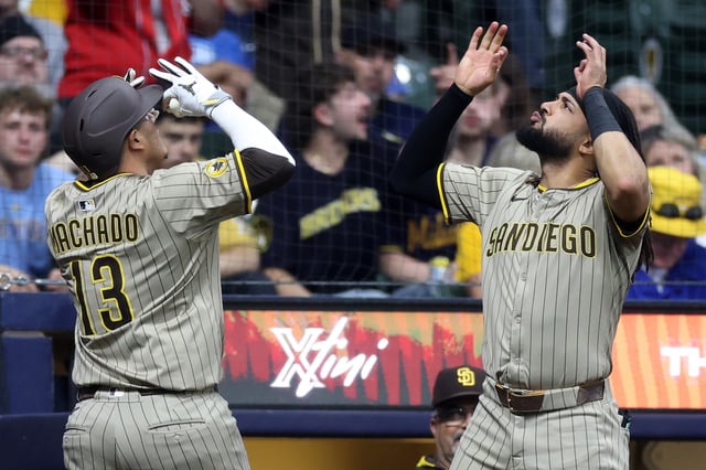 Manny Machado #13 of the San Diego Padres is congratulated by Fernando Tatis Jr. #23 following a home run against the Milwaukee Brewers during the eighth inning at American Family Field on June 06, 2025 in Milwaukee, Wisconsin.