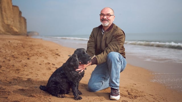 Andrew Malkinson on West Bay in Dorset his spaniel, Basil, who was given to him by his lawyer